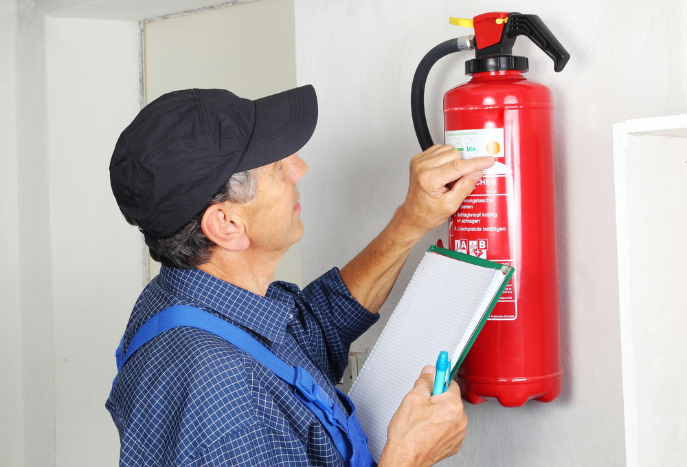 professional checking fire extinguisher
