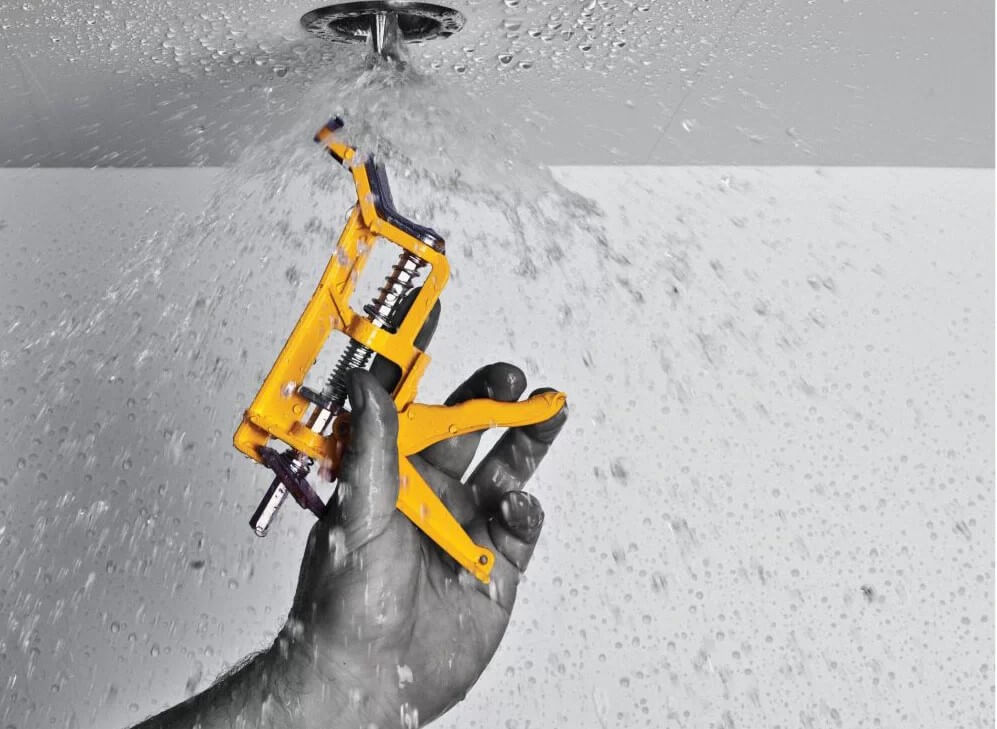 man using fire sprinkler tool