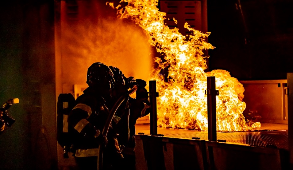 Firefighters fighting a chemical fire at night