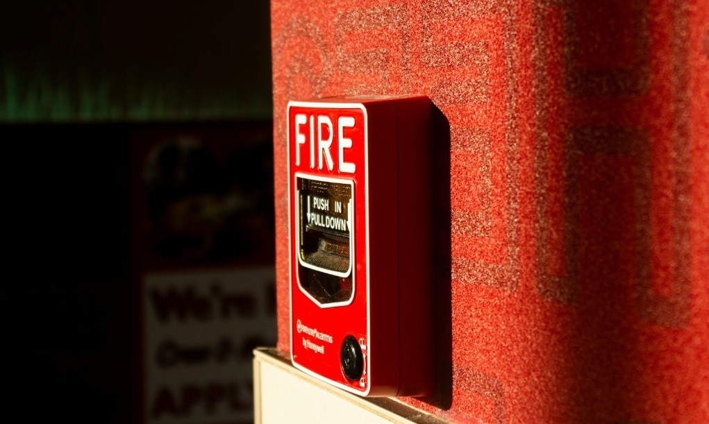 Red fire alarm box mounted on a wall