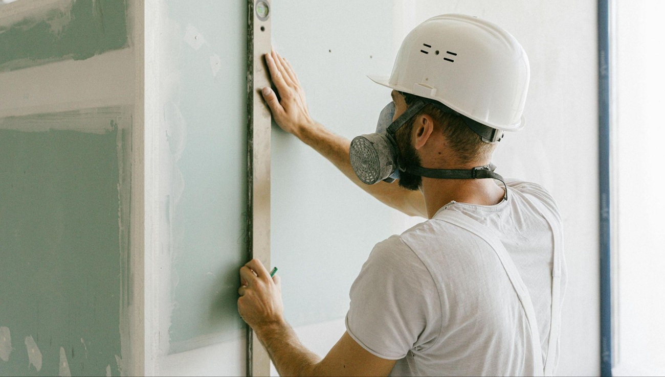 Man installing new drywall
