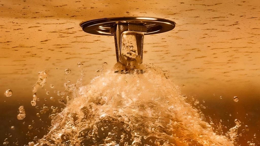 Activated fire sprinkler head releasing water